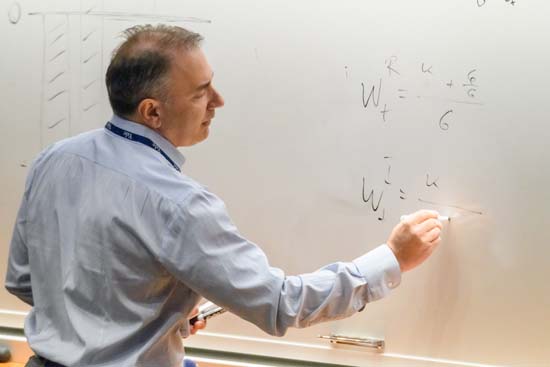 Norman Panageas writing on the whiteboard at the 2022 GE Conference
